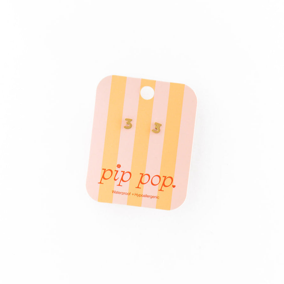 A number 3 earring on packaging with 'pip pop' branding on a white background