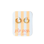 Gold hoop earrings on a striped card with 'pip pop' branding.