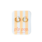 Gold hoop earrings on a striped card with 'pip pop' branding.