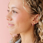 Woman wearing small daisy earring