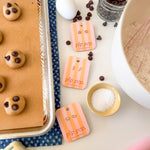 Baking ingredients and tools on a countertop with 'pip pop' packaging.