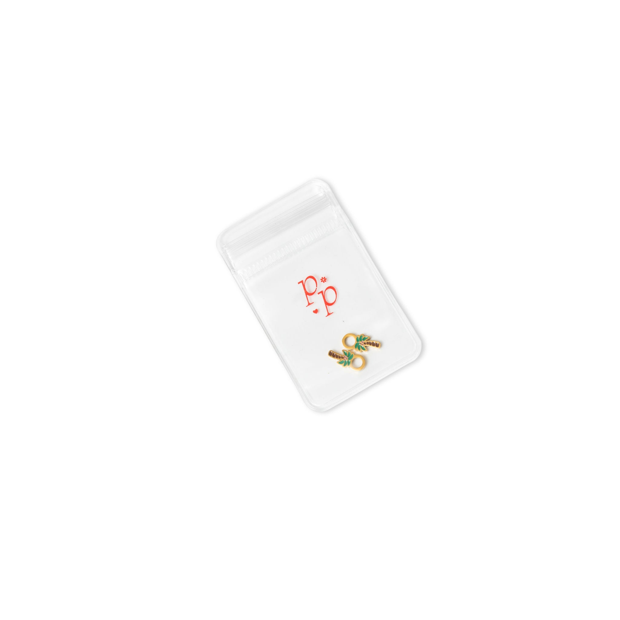 Gold palm tree earring charms in packaging
