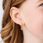 close up of girl wearing a hibiscus flower charm earring