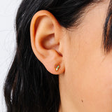 close-up of a girl wearing a colorful snow cone earring 