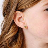 Close-up of a girl wearing a palm tree stud earring