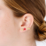 Daisy, heart, flower and rainbow enamel earrings close-up on girl
