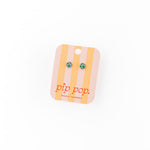Pair of earth 
earrings on a 'pip pop' branded card against a white background