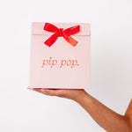 Young girl holding Pip Pop earring gift bag — hypoallergenic kids jewelry gift for birthdays and holidays