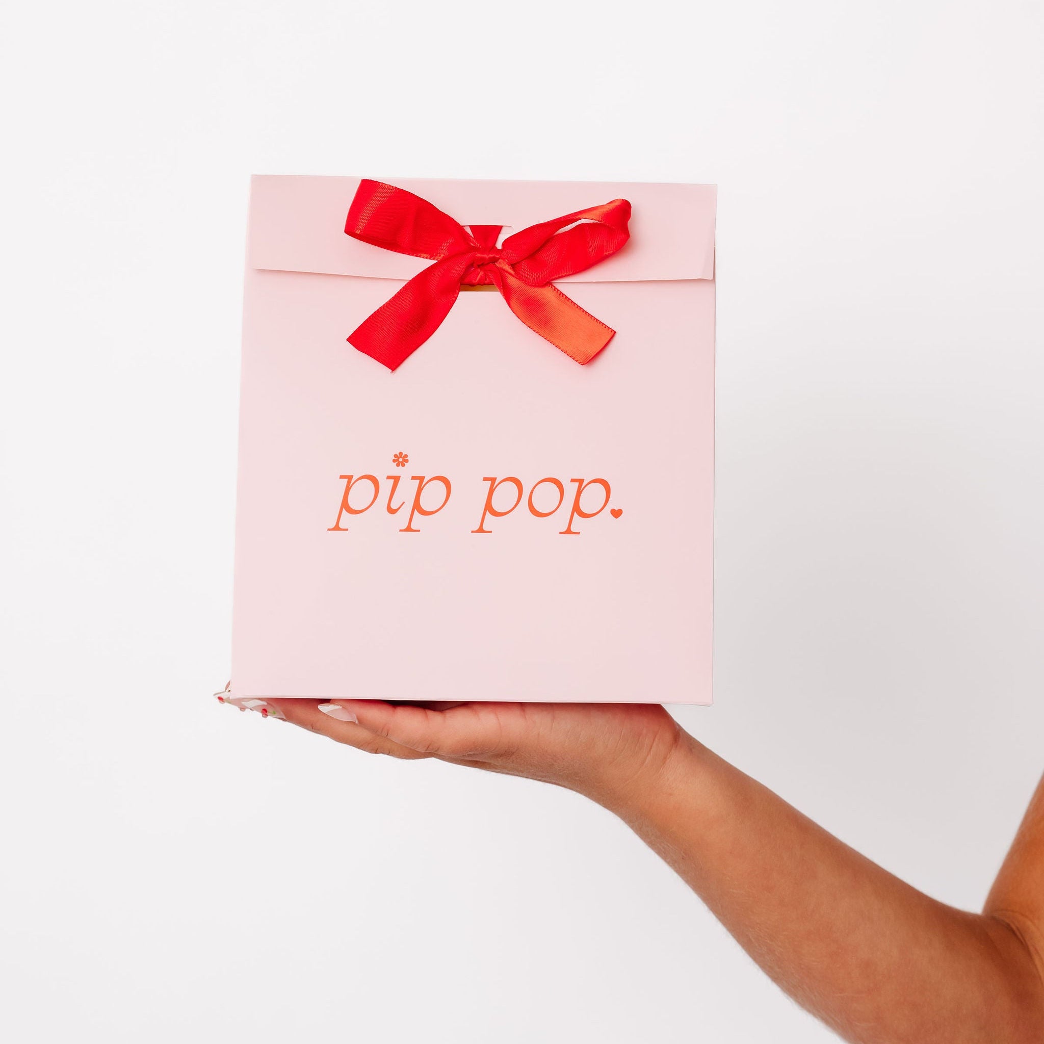 Young girl holding Pip Pop earring gift bag — hypoallergenic kids jewelry gift for birthdays and holidays