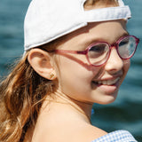Girl by the water wearing a bicycle earring stud