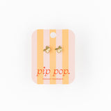 Pair of earrings on a striped card with 'pip pop' branding on a white background