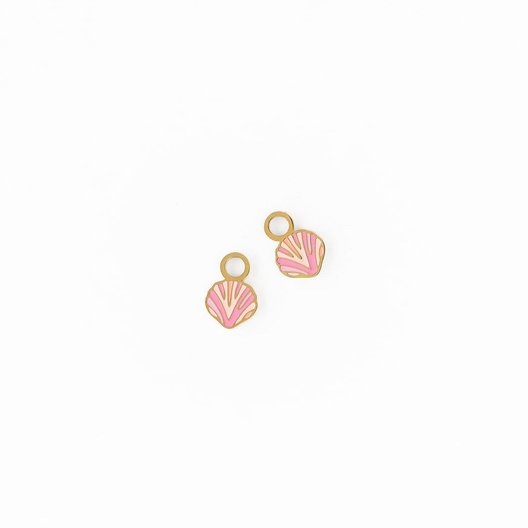 Two shell-shaped charm earrings on a white background