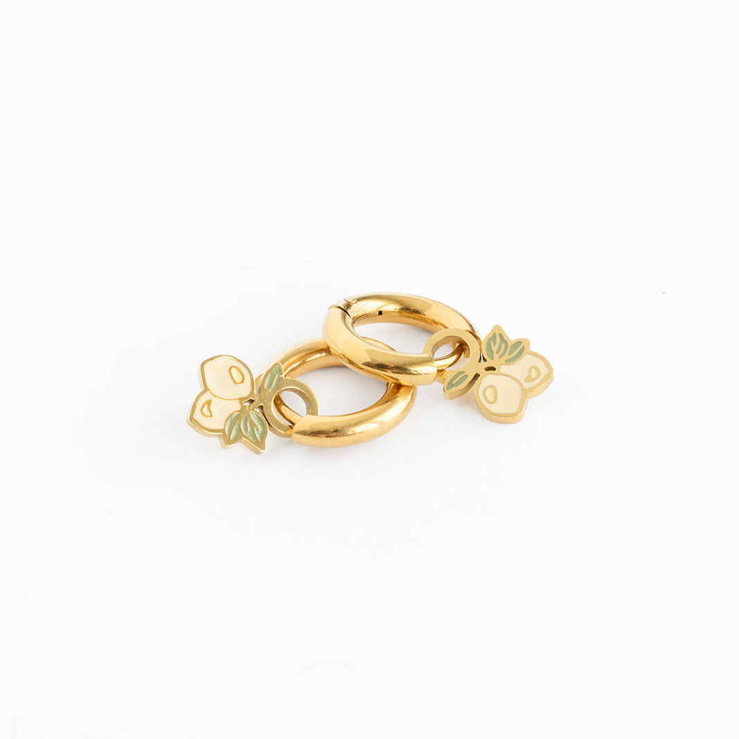 Gold hoop earrings with lemon charms on a white background