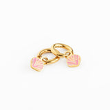 Gold charm with pink seashell earring on a white background