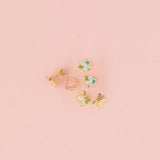 Set of small earrings on a pink background