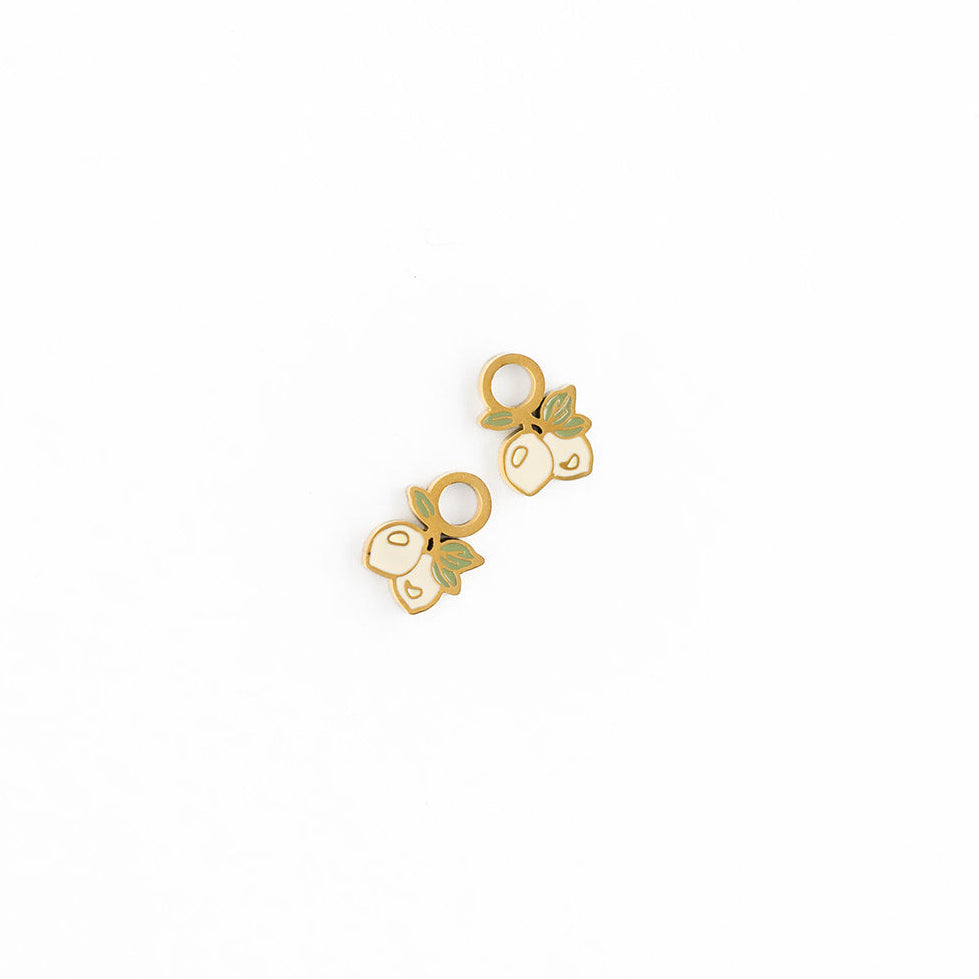 Gold earrings with lemon designs on a white background