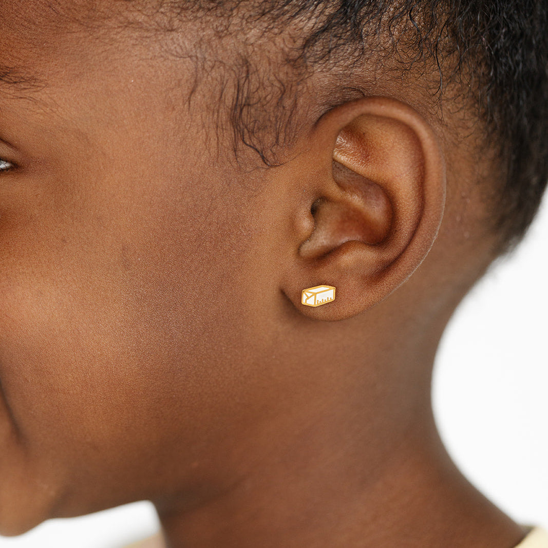 Close-up of a girl wearing a stick of butter earring