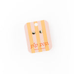 Striped card with yin yang earring on 'pip pop' brand card on a white background