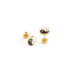 Pair of gold earrings white & black yin yang symbol on a white background